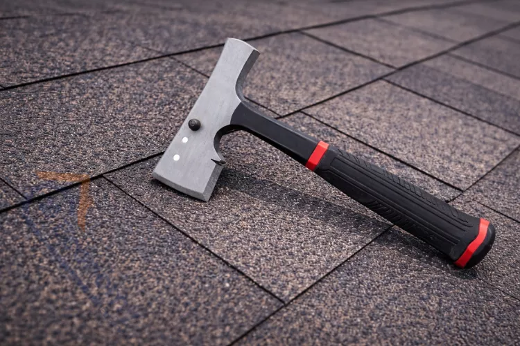 Professional shingling hammer with magnetic head and built-in gauge on asphalt roofing shingles