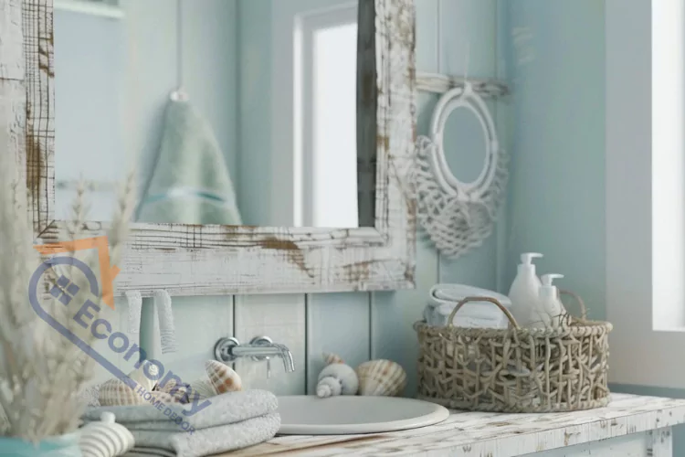 A coastal-themed bathroom with light blue-green shiplap walls, a weathered wood vanity and mirror, a round basin sink, and accessories like a woven basket, seashells, and folded towels.