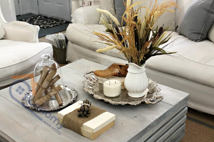 A close-up of a stylish coffee table, showcasing a curated arrangement of books, a small plant, and decorative objects, illustrating elegant Coffee Table Decor Ideas.