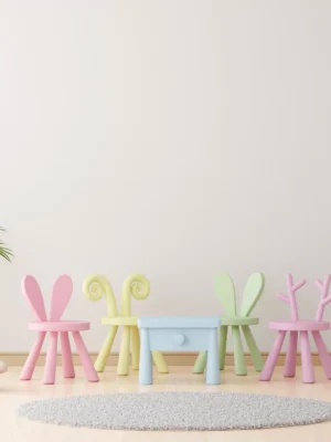 Pastel children's playroom with a blue table, animal-ear chairs in pink, yellow, and green, a white unicorn toy, and potted plants.