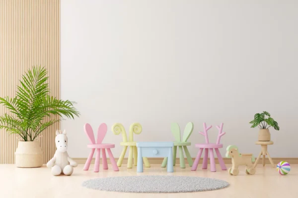 Pastel children's playroom with a blue table, animal-ear chairs in pink, yellow, and green, a white unicorn toy, and potted plants.