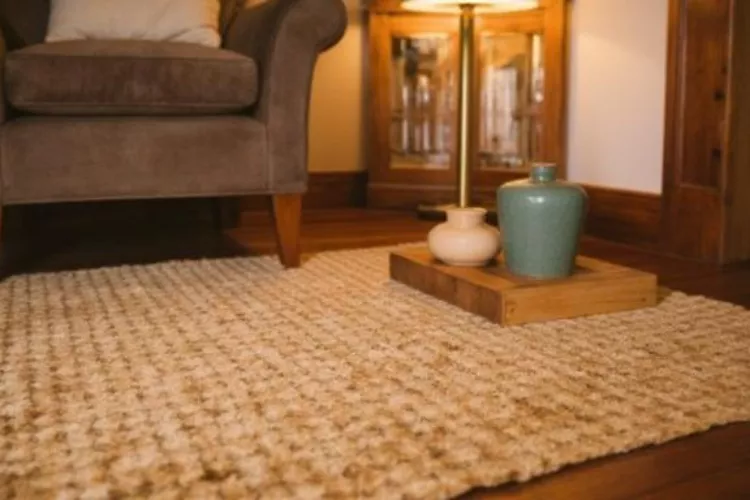 jute rug on dark hardwood floors with brass lamp layered lighting texture contrast