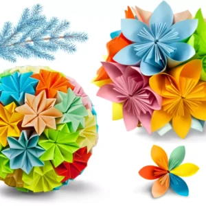 Set of colorful modular origami paper decorations, including a large sphere, a flower cluster, and an individual flower, with a blue frosted pine branch.