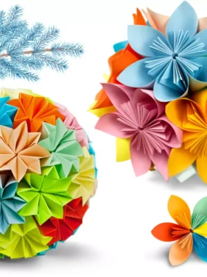 Colorful Modular Origami Paper Decoration Set Set of colorful modular origami paper decorations, including a large sphere, a flower cluster, and an individual flower, with a blue frosted pine branch.