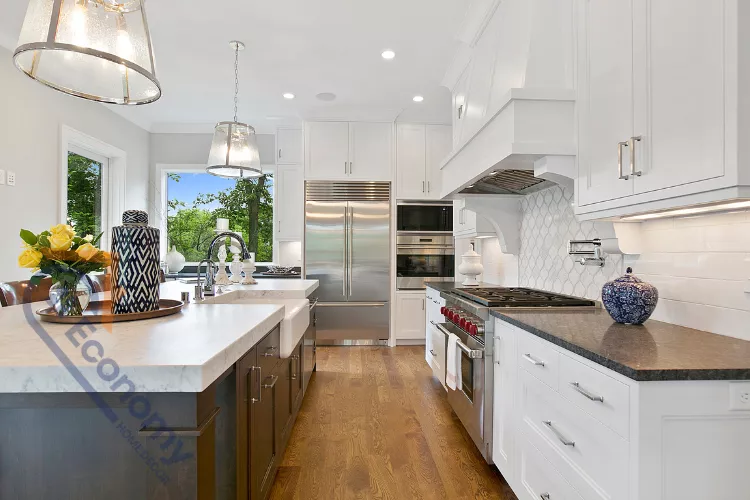 A bright, custom kitchen demonstrating DIY Kitchen Wall Decor Ideas, featuring white cabinets and high-end appliances.