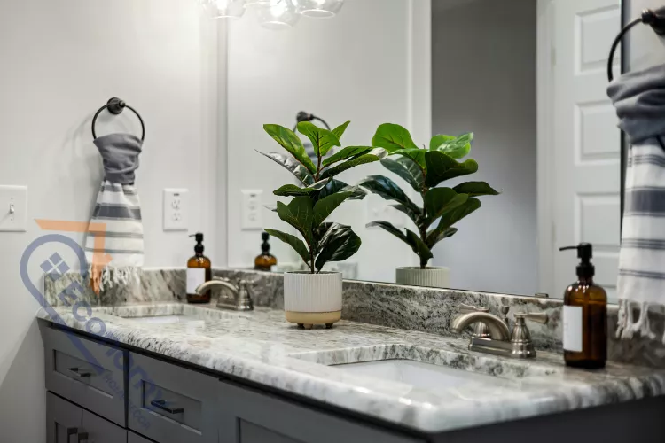 A modern bathroom vanity featuring a faux Fiddle Leaf Fig plant to decorate a bathroom mirror and countertop.