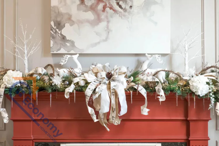 A beautiful Christmas garland draped over a terracotta-red fireplace mantel, featuring a large white paper bow centerpiece.