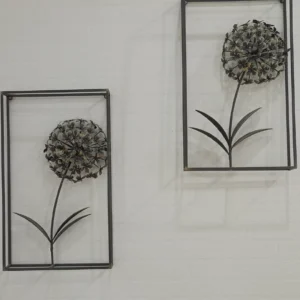 Set of two industrial chic metal dandelion wall art pieces in black rectangular frames against a white textured wall.