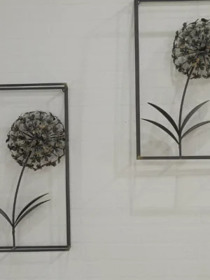 Set of two industrial chic metal dandelion wall art pieces in black rectangular frames against a white textured wall.