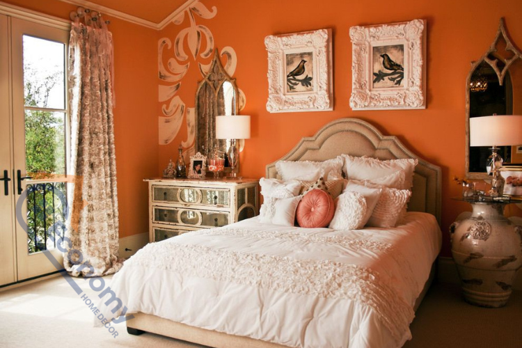 A feminine bedroom showcasing Orange Bedroom Decor Ideas with a vibrant orange accent wall and white ruffled bedding.