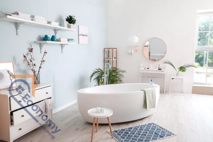 A bright and airy pool bathroom or spa-like guest bath, featuring a freestanding oval tub against a light blue and white wall.