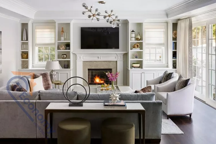 A sophisticated living room showcasing Transitional Decor Ideas, blending traditional built-ins with modern lighting and furniture.