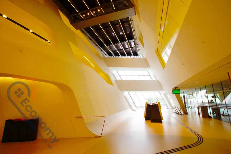 A stunning, multi-story curved staircase wall featuring an extensive gallery of framed artwork and photos.