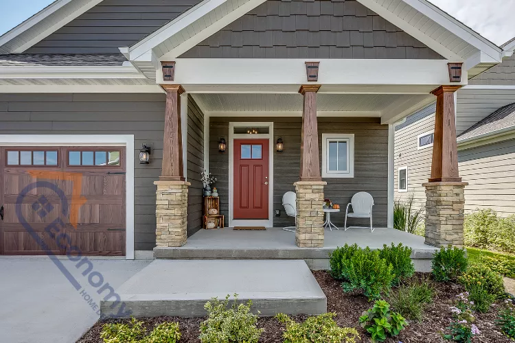 A festive fall front entry decorating idea with a large grouping of orange pumpkins, gourds, and decorative white lanterns.