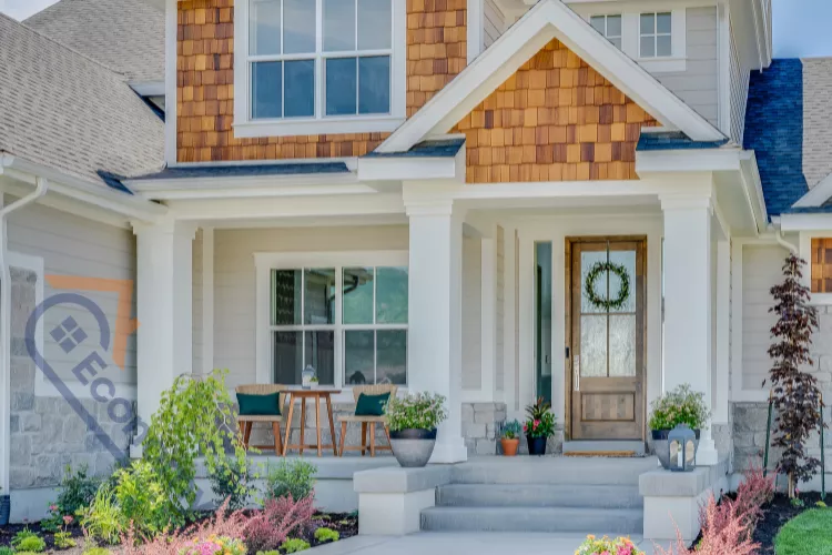 A classic front door entry with a dark, stained wood door, sidelights, and a decorative gold-toned kick plate.