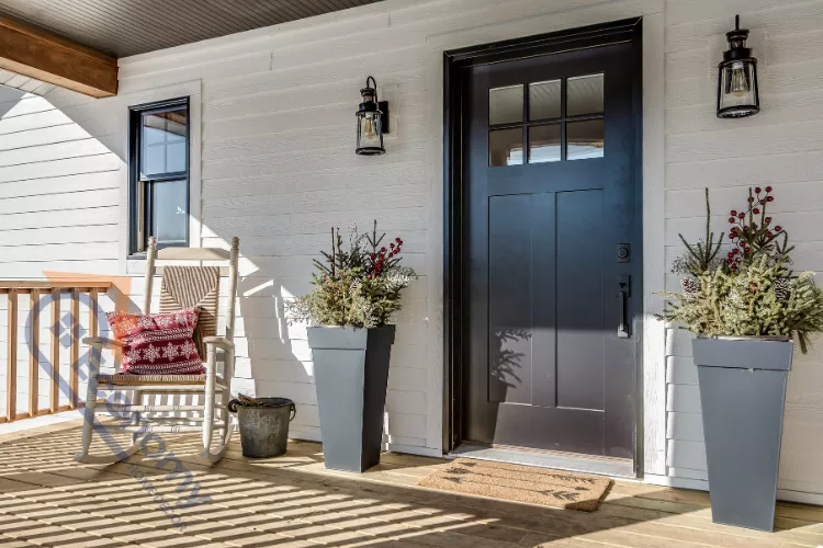A white farmhouse front entry with a dark gray door and sidelights, showcasing welcoming decor ideas.