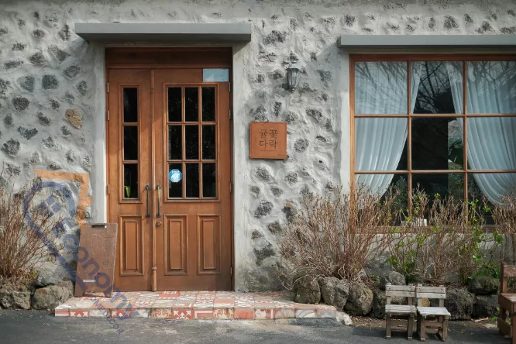 A colorful front door fall decor idea featuring a vibrant wreath made of autumn leaves and berries.