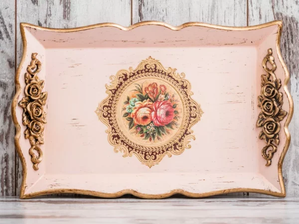 Ornate vintage shabby chic serving tray in distressed pink and cream with gold trim and a central floral bouquet decal.