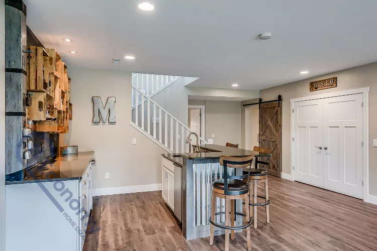 A welcoming basement bedroom decorating idea featuring a queen-size bed, a simple headboard, and soft lighting.