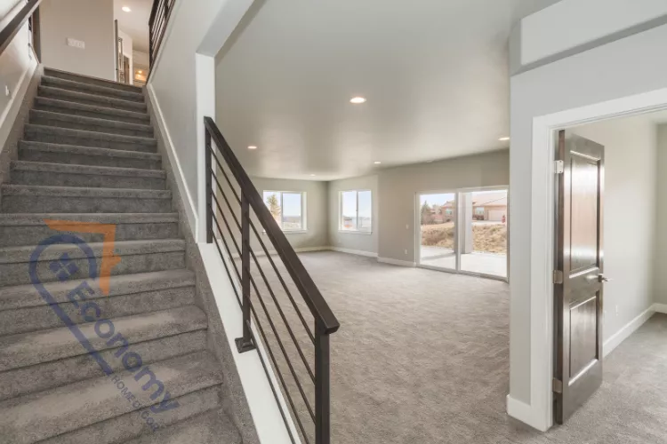 A functional basement room decorating idea featuring a media console, a television, and ample floor space.