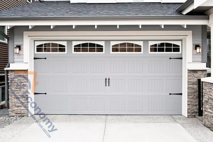 A welcoming front door decor idea featuring two tall, rustic wooden lanterns and lush potted plants.