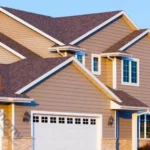 A modern residential home showcasing multiple roof peaks and gable roof decoration ideas using varied siding textures.