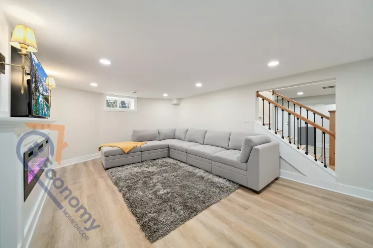 A modern basement color idea decorating a room with a vibrant blue or teal accent wall behind a white sofa.