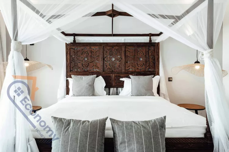 A bedroom with a calm aesthetic featuring three minimalist landscape paintings as the over the bed wall decor.