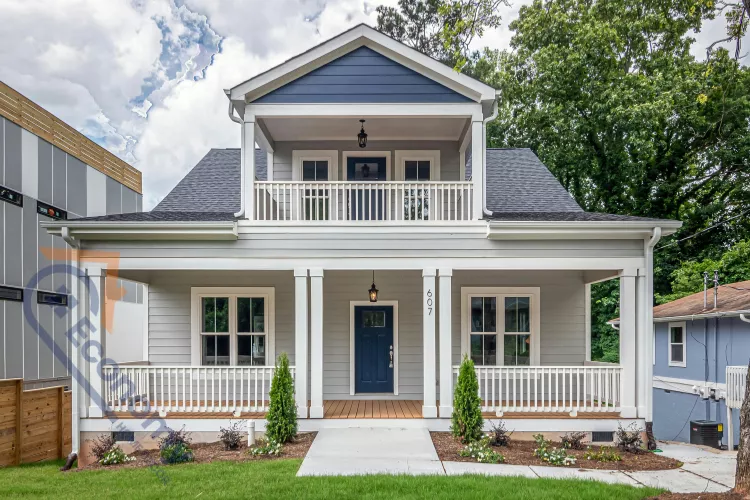 A vibrant porch decorating idea featuring a bright blue front door and matching blue and white patterned ceramic planters.