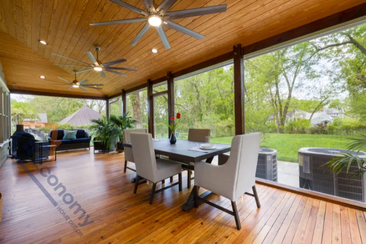 A serene screen porch decor idea featuring a neutral palette with gray wicker furniture and soft textiles.