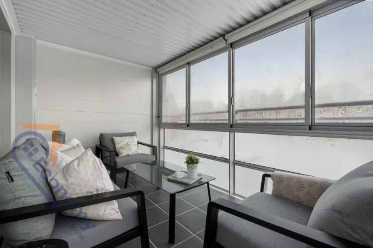 A charming screened porch decorating idea featuring white furniture with light blue coastal-themed accents.