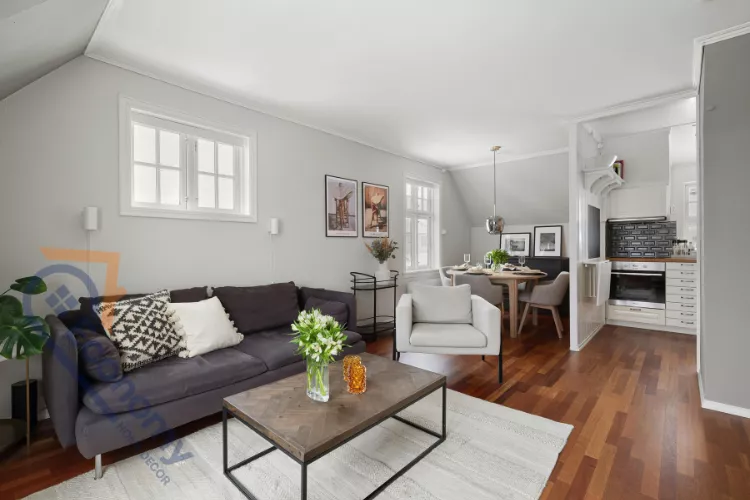 A sunny kitchen corner in a studio flat showcasing decor ideas with potted herbs and plants on a windowsill.