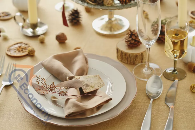 A rustic Thanksgiving table decor idea with linen napkins, wooden accents, and an individual mini pumpkin place setting.