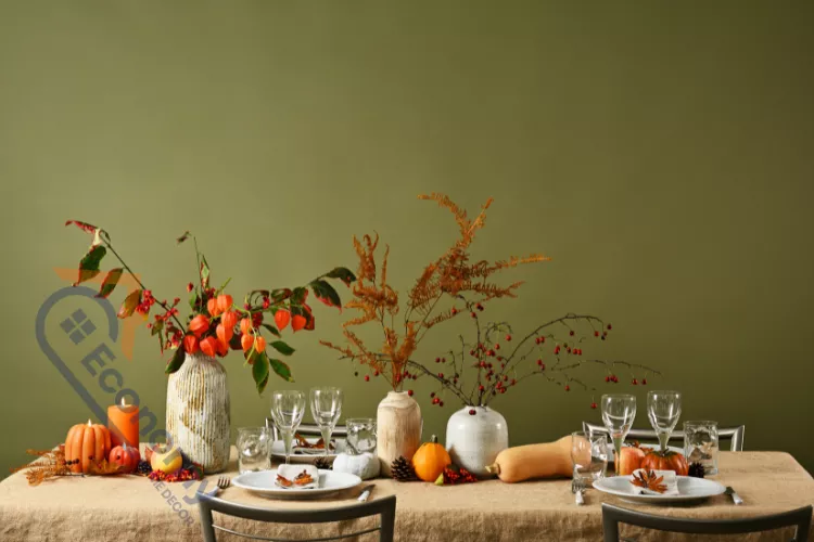 A casual Thanksgiving table decorating idea featuring a buffet or console table set up with drinks and fall foliage.