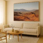 Modern wall art ideas featuring a large abstract canvas above a minimalist sofa in a bright living room